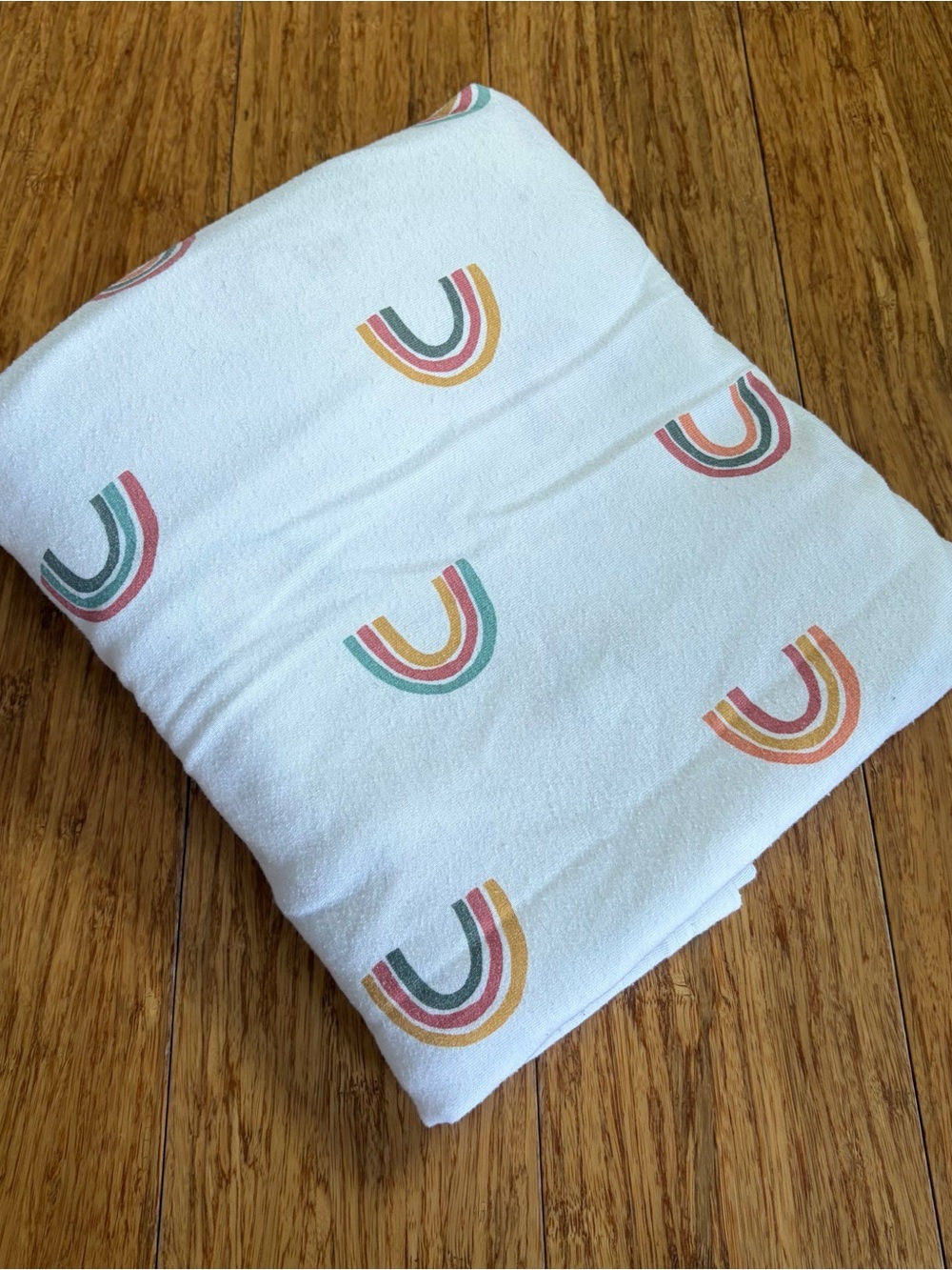 cloud island White Baby Blanket with Muted Rainbow Print
